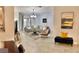 Spacious living room featuring stylish furnishings, a modern chandelier, and neutral tile flooring at 924 Peregrine Hill Pl, Ruskin, FL 33570