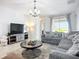 Cozy living room featuring a comfortable sectional sofa, stylish rug, and modern decor at 924 Peregrine Hill Pl, Ruskin, FL 33570