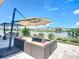 View of the patio, sofa, and lounge area featuring backyard pond with views of neighboring homes at 924 Peregrine Hill Pl, Ruskin, FL 33570