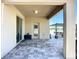 Tiled covered patio with sliding glass door and view to backyard, ideal for outdoor relaxation at 924 Peregrine Hill Pl, Ruskin, FL 33570