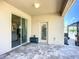 Covered outdoor patio featuring a tile floor, sliding glass doors, and a view of the backyard at 924 Peregrine Hill Pl, Ruskin, FL 33570