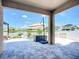 Covered patio showing an outdoor living space overlooking a landscaped backyard and lake view at 924 Peregrine Hill Pl, Ruskin, FL 33570