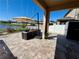 Stylish covered patio featuring comfortable seating, a shade umbrella, and serene lakeside scenery at 924 Peregrine Hill Pl, Ruskin, FL 33570