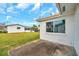 Exterior shot of backyard with a concrete patio, and green grass, perfect for outdoor activities at 9915 39Th N St # 3, Pinellas Park, FL 33782