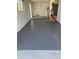 Clean garage featuring a freshly painted floor and ample space for parking and storage at 9915 39Th N St # 3, Pinellas Park, FL 33782