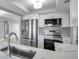 Modern kitchen with stainless steel appliances, white cabinetry, and quartz countertops at 9915 39Th N St # 3, Pinellas Park, FL 33782