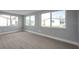 Bright living room with large windows, light gray walls, and light wood-look floors at 9915 39Th N St # 3, Pinellas Park, FL 33782
