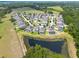 Bird's-eye view of neighborhood featuring retention pond and homes with private pools at 10428 Arbor Groves Pl, Riverview, FL 33578