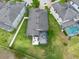 Aerial view of a home with a screened-in porch, hot tub, and outdoor patio at 10428 Arbor Groves Pl, Riverview, FL 33578