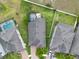 Expansive aerial view of a home featuring a screened-in pool, a jacuzzi, and a well-manicured lawn at 10428 Arbor Groves Pl, Riverview, FL 33578
