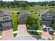 Aerial view showcasing a well-maintained home with brick driveway and lush green lawn in a friendly neighborhood at 10428 Arbor Groves Pl, Riverview, FL 33578