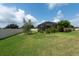 Green backyard with a screened-in patio, providing an ideal space for outdoor relaxation and entertaining at 10428 Arbor Groves Pl, Riverview, FL 33578
