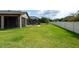 Expansive backyard featuring a well-maintained lawn and a screened-in patio area for outdoor enjoyment at 10428 Arbor Groves Pl, Riverview, FL 33578