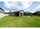 Lush backyard with a screened-in patio, offering plenty of space for outdoor activities and relaxation at 10428 Arbor Groves Pl, Riverview, FL 33578