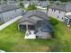 Aerial view of a backyard featuring an enclosed patio with a hot tub and seating area at 10428 Arbor Groves Pl, Riverview, FL 33578