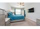 Cozy bedroom features a ceiling fan and a television mounted on the wall at 10428 Arbor Groves Pl, Riverview, FL 33578