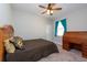 Welcoming bedroom with a rolltop desk, ceiling fan, and neutral carpeting at 10428 Arbor Groves Pl, Riverview, FL 33578