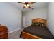 Bedroom with neutral carpeting, ceiling fan, and simple decor creates a relaxing atmosphere at 10428 Arbor Groves Pl, Riverview, FL 33578