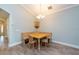 Cozy dining area with corner seating, wood flooring, and a decorative wall cabinet at 10428 Arbor Groves Pl, Riverview, FL 33578