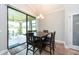 Dining area with sliding glass doors that lead to an outdoor patio with ceiling fan at 10428 Arbor Groves Pl, Riverview, FL 33578