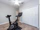 This view of the workout area exhibits the stationary bike and white double door closet at 10428 Arbor Groves Pl, Riverview, FL 33578