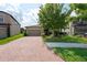 Attractive home with a brick driveway, beautiful landscaping, and a well-kept lawn providing excellent curb appeal at 10428 Arbor Groves Pl, Riverview, FL 33578