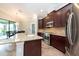 Kitchen with stainless steel appliances, granite counters, and dark wood cabinets at 10428 Arbor Groves Pl, Riverview, FL 33578