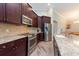 Modern kitchen with stainless steel appliances, granite counters, and dark cabinetry at 10428 Arbor Groves Pl, Riverview, FL 33578