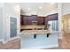 Modern kitchen with stainless steel appliances, granite counters, and dark cabinetry at 10428 Arbor Groves Pl, Riverview, FL 33578