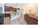 Spacious kitchen features dark wood cabinetry, stainless steel appliances, and island with granite countertops at 10428 Arbor Groves Pl, Riverview, FL 33578
