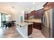 Bright kitchen featuring stainless steel appliances, granite counters, and a large island at 10428 Arbor Groves Pl, Riverview, FL 33578