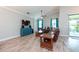 Inviting living room boasts wood floors, a TV, comfortable seating, and access to the outdoor area at 10428 Arbor Groves Pl, Riverview, FL 33578