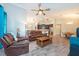 Spacious living room with leather furniture, open floor plan, and inviting decor at 10428 Arbor Groves Pl, Riverview, FL 33578