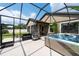 Inviting screened-in patio with a hot tub, grill, and ample seating for outdoor entertaining and leisure at 10428 Arbor Groves Pl, Riverview, FL 33578