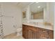 Bathroom features wood vanity with marble countertop, decorative mirror and ceramic tile flooring at 11 Baymont St # 1403, Clearwater Beach, FL 33767