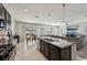 Open kitchen concept featuring stainless appliances, a large island, and seamless connection to living area at 11603 Fringetree Ct, Riverview, FL 33579