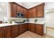 This kitchen features cherry wood cabinets, white countertops and stainless steel appliances at 12027 Wandsworth Dr, Tampa, FL 33626