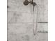 Marble shower featuring a dual shower head and sleek glass shelves at 12027 Wandsworth Dr, Tampa, FL 33626