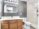 Modern bathroom featuring a framed mirror, wooden drawers, toilet, and shower with glass doors at 1208 Chatham Pine Pl, Brandon, FL 33511