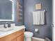 Modern bathroom features a new vanity with illuminated mirror, a toilet, and decorative wall hangings at 1208 Chatham Pine Pl, Brandon, FL 33511