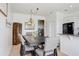 Dining room featuring a table with chairs and a rustic chandelier with kitchen in the background at 1208 Chatham Pine Pl, Brandon, FL 33511