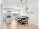 Dining area featuring a table with chairs, a bench, and a modern chandelier at 1208 Chatham Pine Pl, Brandon, FL 33511