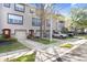 Townhome exteriors featuring neutral paint, dark trim, garages, and well-maintained landscaping at 1208 Chatham Pine Pl, Brandon, FL 33511
