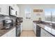 Bright kitchen with white cabinets, stainless steel appliances, and granite countertops at 1208 Chatham Pine Pl, Brandon, FL 33511