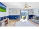 Bright living room featuring hardwood floors, ceiling fan, and sliding glass door with lake view at 1208 Chatham Pine Pl, Brandon, FL 33511