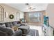 Bright living room features stylish decor, a ceiling fan, and a large window for ample natural light at 1208 Chatham Pine Pl, Brandon, FL 33511