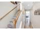 Staircase with wood and white railing, complemented by wood-look tile steps at 1208 Chatham Pine Pl, Brandon, FL 33511
