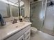 Clean bathroom featuring white cabinets, white tiled shower, and modern fixtures for a comfortable experience at 1235 S Highland Ave # 1-204, Clearwater, FL 33756