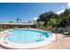 Sparkling community pool with lounge chairs and beautiful landscaping, perfect for relaxation at 1235 S Highland Ave # 1-204, Clearwater, FL 33756