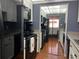 Well-lit kitchen with black appliances and white cabinets offering a blend of style and functionality at 1235 S Highland Ave # 1-204, Clearwater, FL 33756